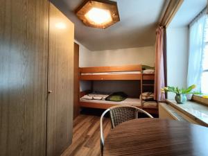 a small room with a table and a bunk bed at Oberweinfeld in Berchtesgaden
