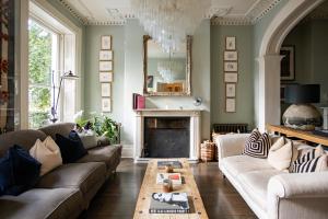 a living room with a couch and a fireplace at No38 The Park in Cheltenham