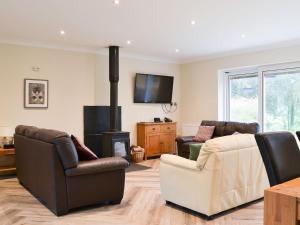 a living room with a couch and a fireplace at Lucys At The Grange - Uk11519 in Mockerkin