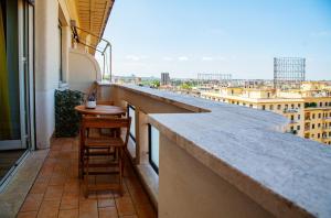 a balcony with a bar with a view of a city at City Lights Rome in Rome