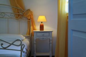 a bedroom with a bed and a table with a lamp at Belvedere Apartments in Chora Folegandros