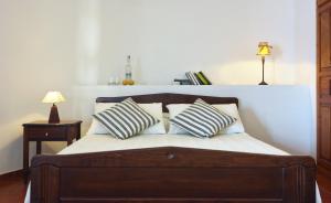 a bed with two pillows on it in a room at Belvedere Apartments in Chora Folegandros