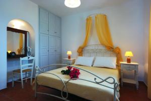 a bedroom with a bed with flowers on it at Belvedere Apartments in Chora Folegandros