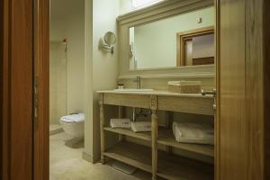 a bathroom with a sink and a mirror and a toilet at La Boheme Boutique Casa Soare in Bucharest +76 photos