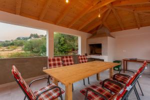 a dining room with a wooden table and chairs at Secluded house - guaranteed privacy in Klis