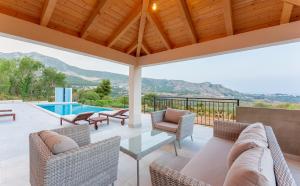 a patio with chairs and a table and a swimming pool at Secluded house - guaranteed privacy in Klis