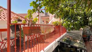 a balcony with two chairs and a fish tank at Casa do Bairro by Shiadu in Lisbon