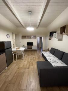 a large living room with a couch and a kitchen at Sea apartments in Terracina