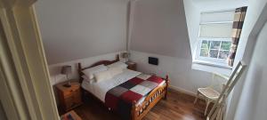 a small bedroom with a bed and a window at Lough Rynn View accommodation Room only in Mohill