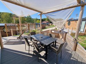 a patio with a table and chairs on a deck at Seaside-Resort in Geiselwind