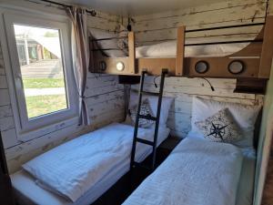 two bunk beds in a room with a window at Seaside-Resort in Geiselwind