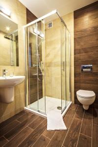 a bathroom with a shower and a toilet and a sink at Kraina Smaku in Zakopane