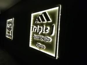 um sinal para um café de todos os ritos na parede em Triple J Hometel em Bang Tao Beach