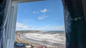 a view of the beach from a window at Areawest in Scarborough