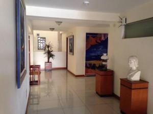 a hallway with a bust of a man on a table at Hotel Ivansino Inn in Chimbote