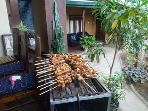 a bunch of food cooking on a grill at Ella green stay in Ella