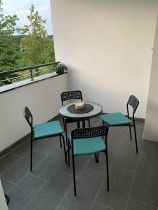 a table and chairs on a balcony with a view at Apartman Diamond in Paraćin