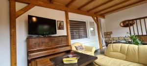 a living room with a flat screen tv on a wall at Auf dem Reiterhof in Wernigerode