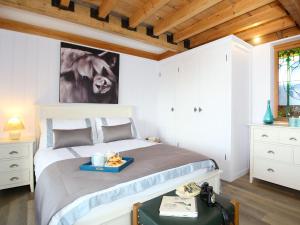 a bedroom with a bed with a tray on it at The Barn At Banks Cottage in Pulborough