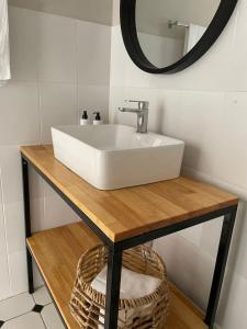a bathroom with a white sink and a mirror at 9 Coogee Bay in East London +12 photos