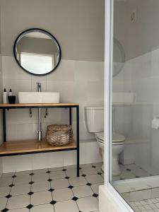 a bathroom with a sink and a mirror at 9 Coogee Bay in East London