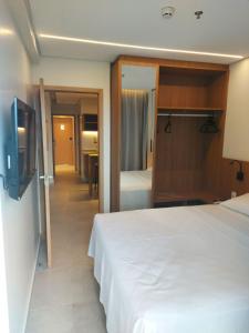 een hotelkamer met een bed en een televisie bij Apartamento Salinas Premium Resort in Salinópolis