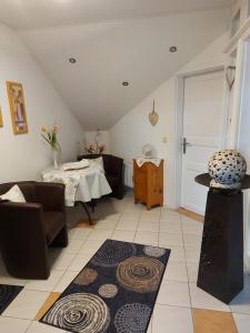 a living room with a table and some chairs at Ferienwohnung Schmitz in Anschau