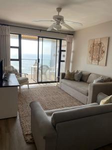 a living room with a couch and a table at 9 Coogee Bay in East London