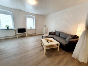 a living room with a couch and a table at Ferienwohnung in Gersheim / bis 4 Personen in Gersheim