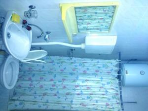 a bathroom with a bed with a toilet and a sink at Hoxha rooms in Ulcinj