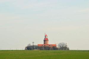 a lighthouse sitting on top of a grass field at Ferienhaus in Kühlungsborn in Kühlungsborn