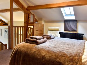 a bedroom with a large bed with blankets on it at Hilltoft Barn in Dockray