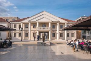a large building with a statue in front of it at Apartman Šarac in Višegrad