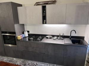 una cucina con lavandino e piano cottura di Appartamento completamente ristrutturato a Montecrestese