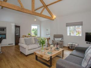 a living room with a couch and a table at Brens Barn in Bedale