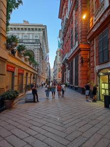 Un gruppo di persone che camminano per strada di Albergo Caffaro a Genova