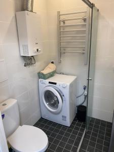 a bathroom with a washing machine and a toilet at Platform Narva in Narva
