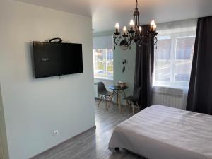 a bedroom with a bed and a flat screen tv on the wall at Platform Narva in Narva