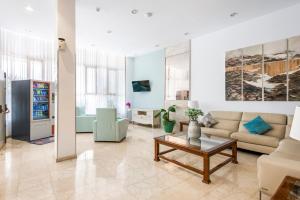a living room with a couch and a table at Hotel Andrea´s in Los Cristianos