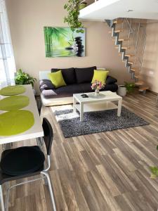 a living room with a couch and a table at Green Island in the downtown with free parking in Debrecen