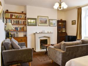 a living room with two couches and a fireplace at Hallams Yard in Skipton