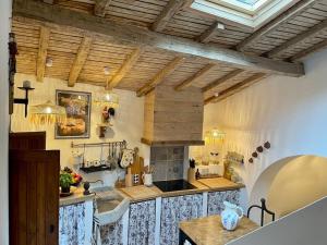 a large kitchen with wooden ceilings and a table at Cottage da Minha Terra 1890 in Geres