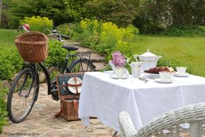 une table avec un vélo garé à côté d'une table avec de la nourriture dans l'établissement La Gentilhommière de Moulins, 