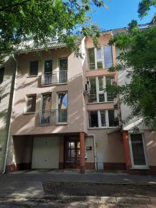 an apartment building with balconies on a street at Kiss-Füredi Apartman Szeged in Szeged