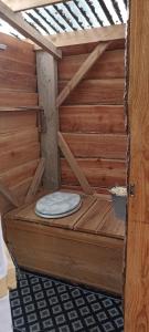 a wooden sauna with a toilet in a room at L'échappée au jardin, yourte bucolique in Godinne