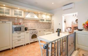 a kitchen with white cabinets and a stove top oven at Casa Maria - Dimora di Charme in Montalcino