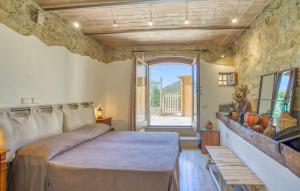 a bedroom with a bed and a large window at Casa Maria - Dimora di Charme in Montalcino