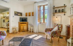 a living room with two chairs and a fireplace at Casa Maria - Dimora di Charme in Montalcino