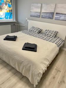a bed with two black towels on top of it at panoramic view and free parking in Vilnius