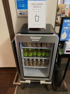 a drink refrigerator with a box on top of it at Roppongi Plaza Hotel in Tokyo